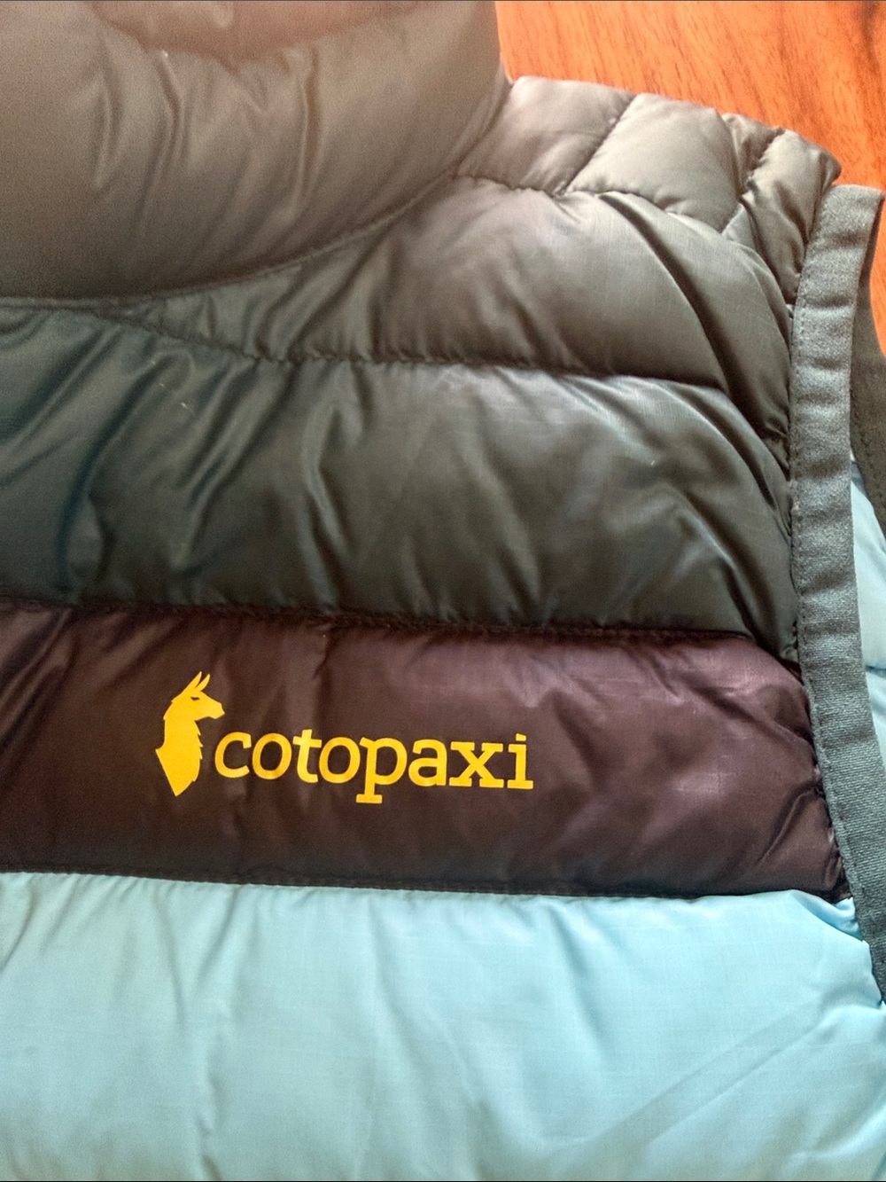 Cotopaxi Teal Puffer Vest with Yellow & Light Blue Stripes - Picture 3 of 4